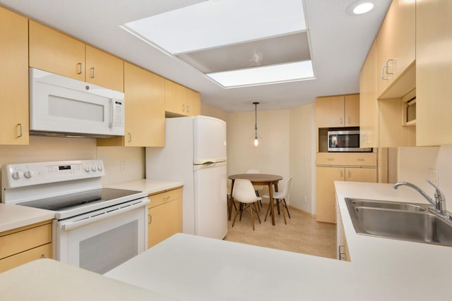 kitchen with hanging light fixtures, sink, light tile patterned floors, light brown cabinetry, and white appliances