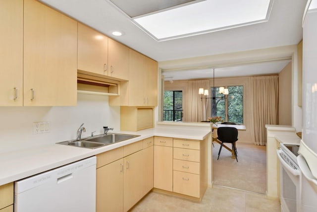 kitchen with light brown cabinets, kitchen peninsula, a notable chandelier, sink, and white appliances