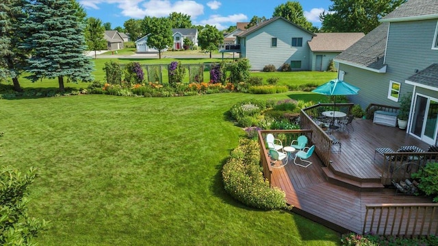 view of yard featuring a deck and outdoor dining area