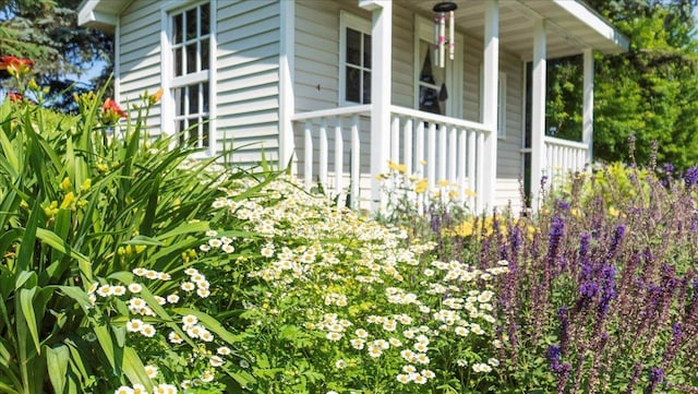 view of side of home with a porch