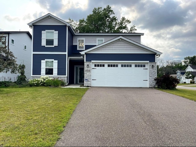 view of front of property featuring a front lawn and a garage