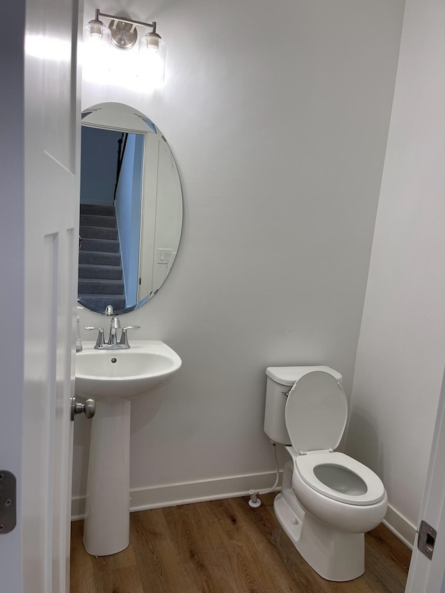 bathroom featuring toilet and hardwood / wood-style flooring