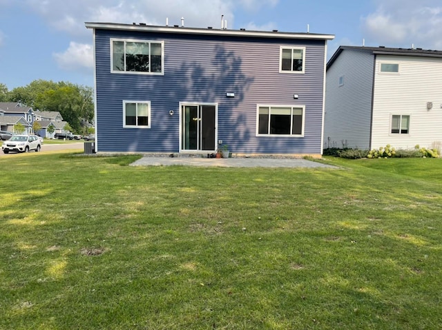 rear view of house featuring a patio and a yard