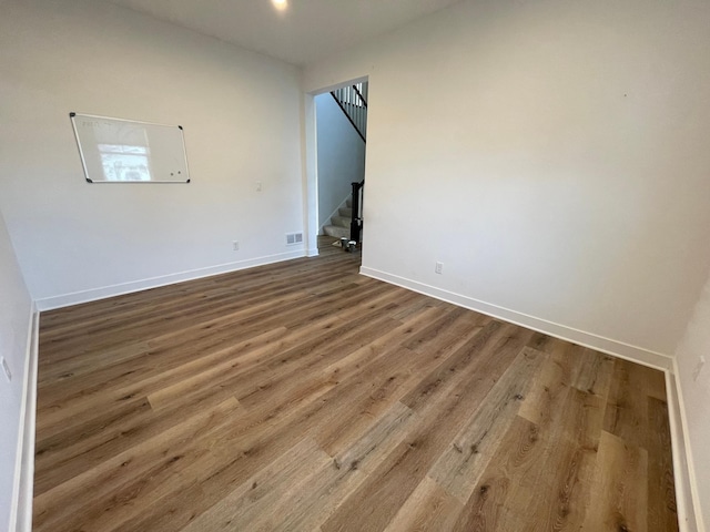 spare room with hardwood / wood-style flooring