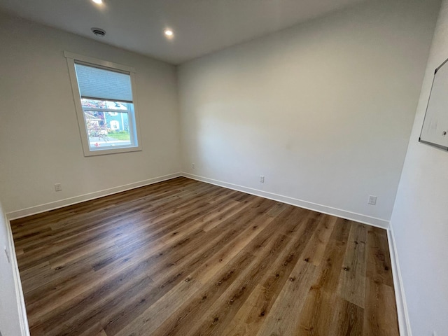 spare room with dark hardwood / wood-style floors