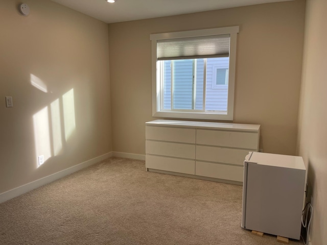 unfurnished room featuring light colored carpet