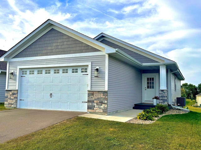 craftsman-style house with a garage, a front lawn, and central air condition unit