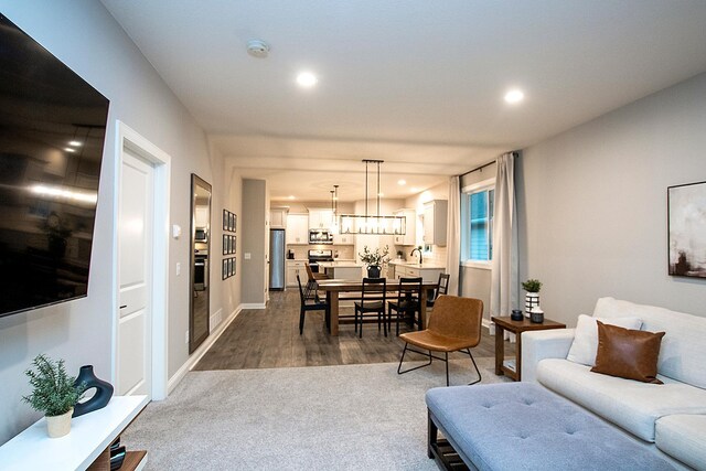 living room with dark hardwood / wood-style floors and sink