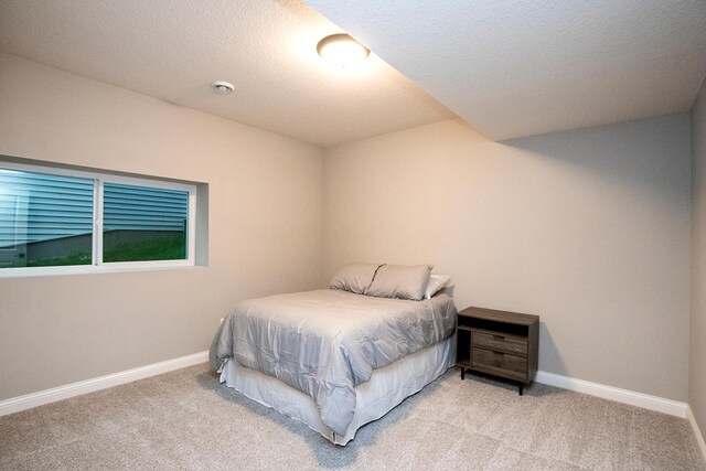 carpeted bedroom featuring a textured ceiling