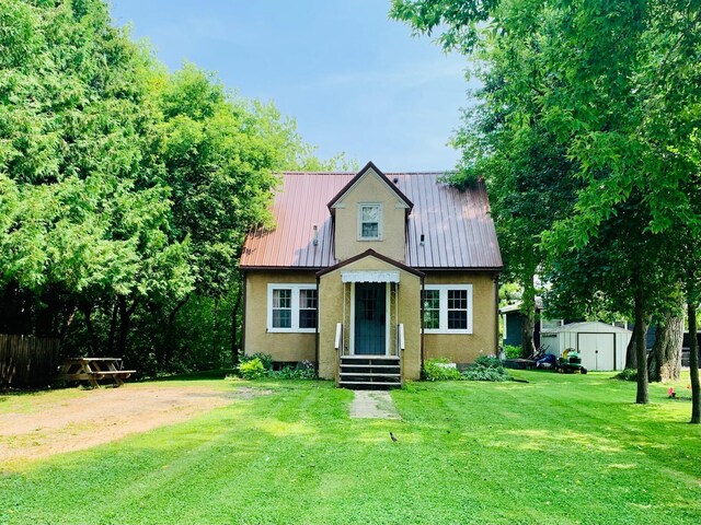 view of front facade with a storage shed and a front yard