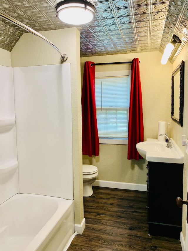 full bathroom featuring vanity, toilet, hardwood / wood-style flooring, and bathing tub / shower combination