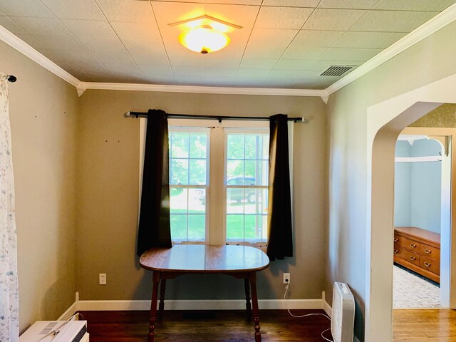 interior space with crown molding and hardwood / wood-style flooring