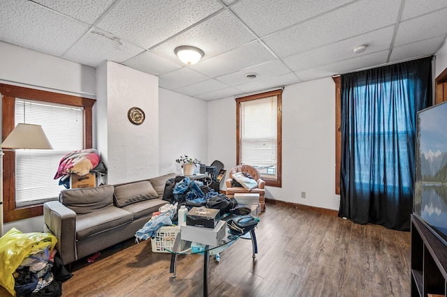 living room featuring plenty of natural light, hardwood / wood-style floors, and a paneled ceiling