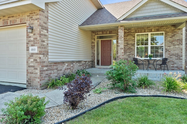 entrance to property with a porch and a garage