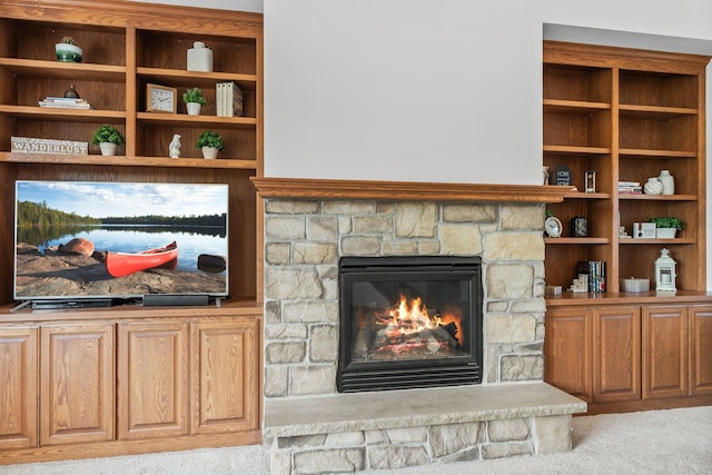 interior details featuring a fireplace and carpet floors