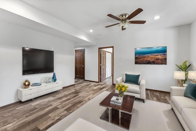 living room featuring ceiling fan and hardwood / wood-style floors