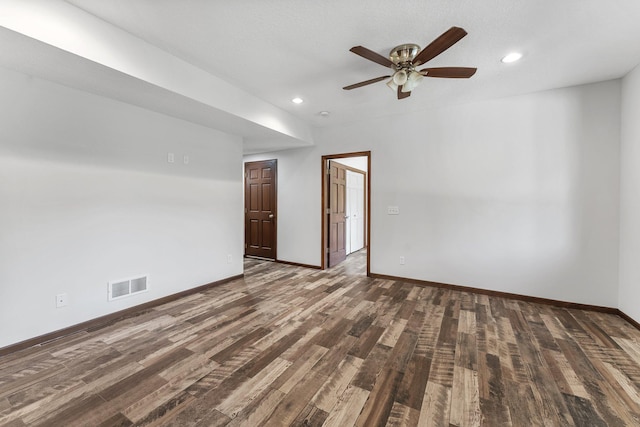 unfurnished room with ceiling fan and dark hardwood / wood-style flooring