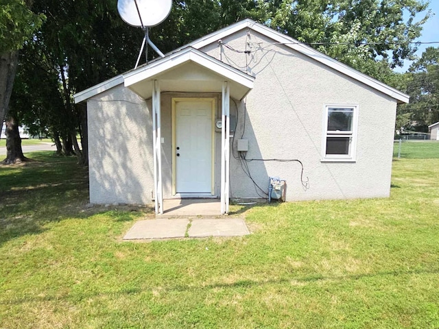 back of house with a yard