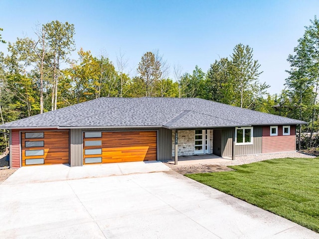 view of front of house with a garage and a front yard