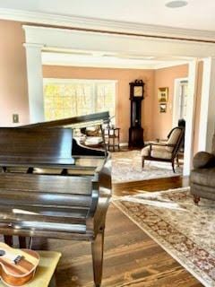 miscellaneous room featuring ornamental molding and hardwood / wood-style floors