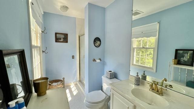 bathroom with a shower with door, toilet, tile patterned flooring, and vanity