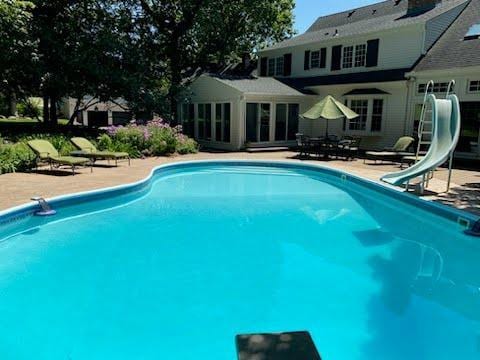 view of swimming pool featuring a patio and a water slide