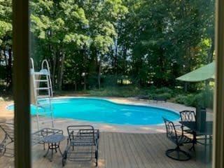 view of pool with a wooden deck