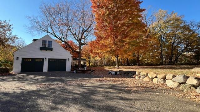 view of property exterior featuring an outdoor structure and a garage