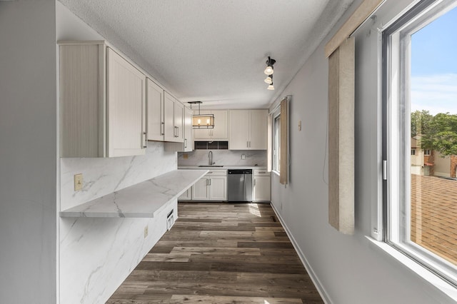 kitchen featuring pendant lighting, white cabinets, dishwasher, and a healthy amount of sunlight