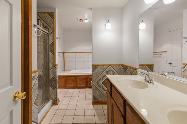 bathroom featuring vanity, tile walls, plus walk in shower, and tile patterned floors