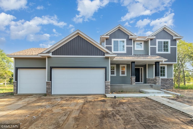 craftsman house featuring covered porch and a garage