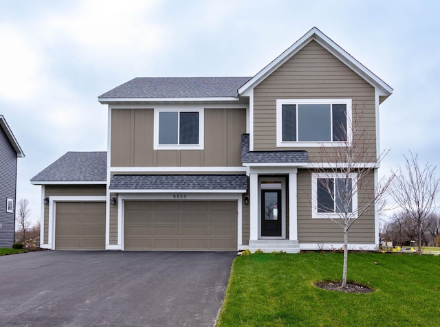 view of front of home featuring a front yard and a garage