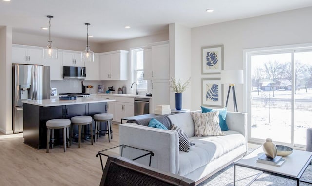 living area with recessed lighting and light wood-style flooring