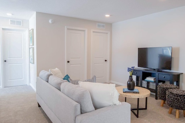 living area featuring light carpet, recessed lighting, visible vents, and baseboards