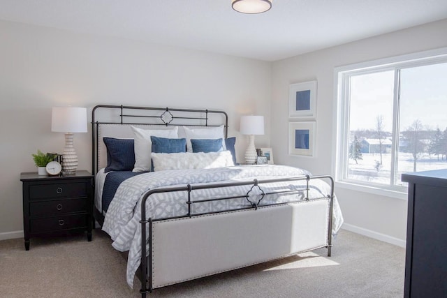 bedroom featuring carpet and baseboards