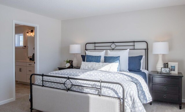 bedroom featuring baseboards, carpet flooring, and ensuite bathroom