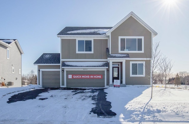 traditional home with central AC unit and board and batten siding