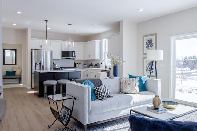 living room featuring light wood-type flooring and recessed lighting