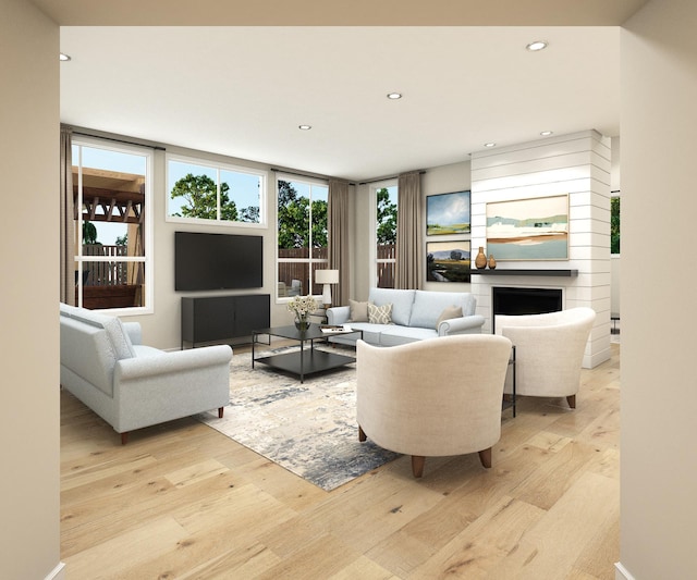living area featuring light wood finished floors, a fireplace, and recessed lighting