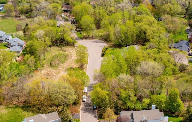 drone / aerial view with a forest view and a residential view