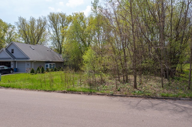 view of property exterior featuring a yard and a garage