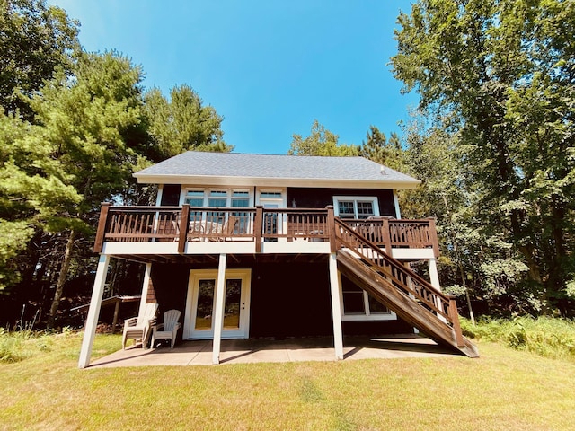 back of house with a lawn, a deck, and a patio area