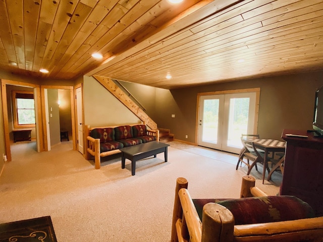 carpeted living room with french doors, plenty of natural light, and wood ceiling