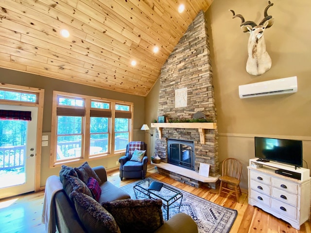 living room featuring high vaulted ceiling, a stone fireplace, a wall mounted air conditioner, and light hardwood / wood-style floors