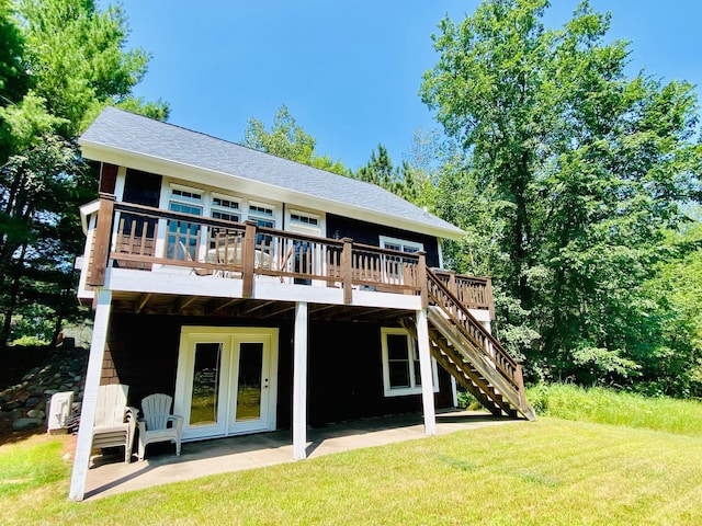 rear view of house featuring a patio, a wooden deck, and a yard