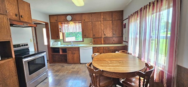 kitchen featuring electric range, dishwasher, sink, and premium range hood