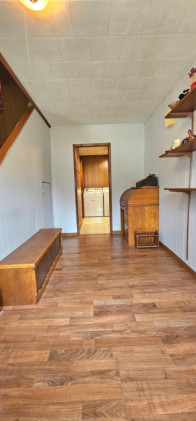 interior space featuring washing machine and dryer and light hardwood / wood-style flooring