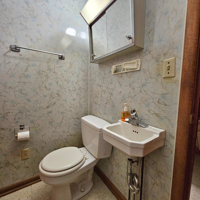 bathroom featuring toilet and sink