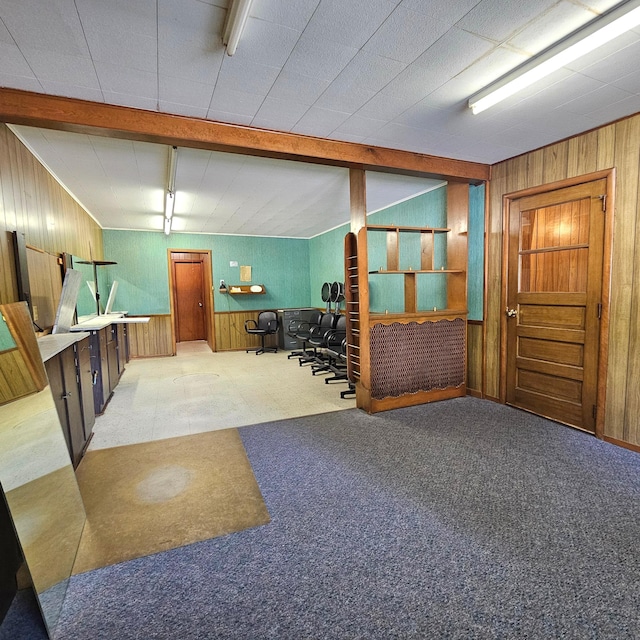 interior space with light carpet and wood walls