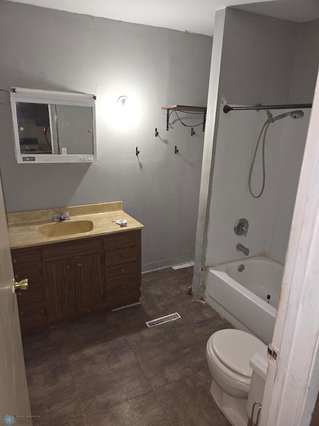 full bathroom with bathing tub / shower combination, tile patterned floors, toilet, and vanity